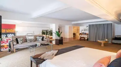 a large living room with a bed and a couch at Centre cannes Galia 210 m2 in Cannes