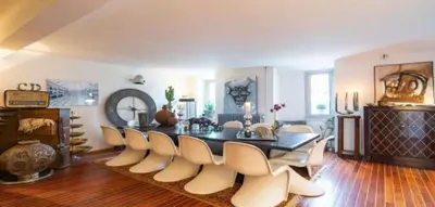 a dining room with a table and a group of chairs at Centre cannes Galia 210 m2 in Cannes