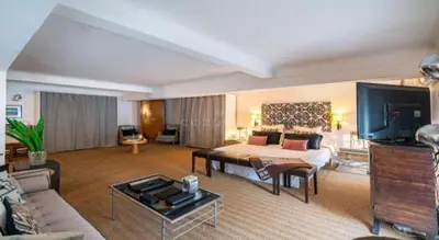 a large living room with a bed and a tv at Centre cannes Galia 210 m2 in Cannes