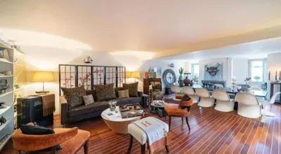 a living room with a couch and tables and chairs at Centre cannes Galia 210 m2 in Cannes