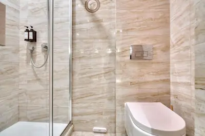 a bathroom with a toilet and a glass shower at Cannes 50m palais & Croisette in Cannes