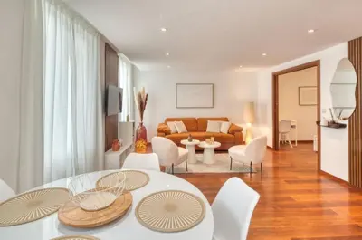 a living room with a couch and a table and chairs at Cannes 50m palais & Croisette in Cannes