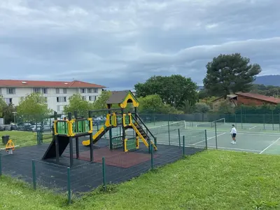 a playground with a slide on a tennis court at 2P jardin Sud vue Lac avec piscine tennis parking privé in Le Cannet