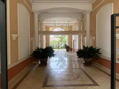 a hallway with potted plants in a building at 2P jardin Sud vue Lac avec piscine tennis parking privé in Le Cannet