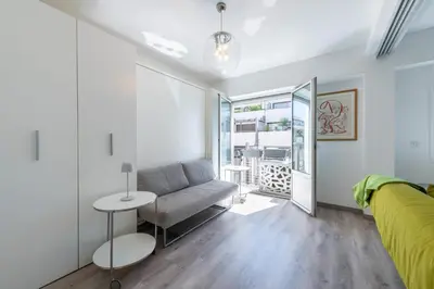 a living room with a couch and a table at Bright Apartment in the Heart of Cannes in Cannes