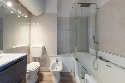 a bathroom with a toilet and a shower and a sink at Bright Apartment in the Heart of Cannes in Cannes