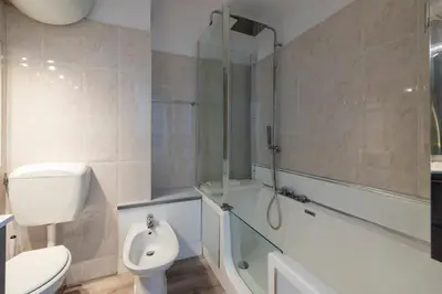 a bathroom with a shower and a toilet and a sink at Bright Apartment in the Heart of Cannes in Cannes