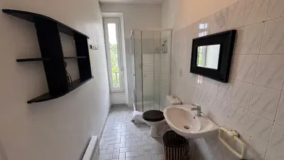 a bathroom with a sink and a toilet and a television at Reine des Mers in Cannes