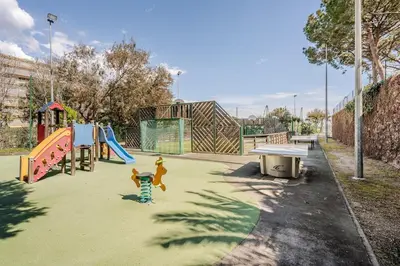 a park with a playground with a slide and a bench at Apartment with Garden, Pool, Sea View and Parking in Cannes