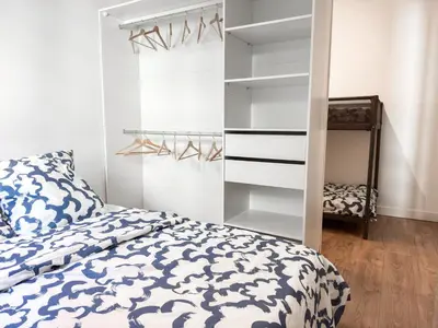 a bedroom with a bed and a closet at Suite Palmiers bleus Cannes in Cannes