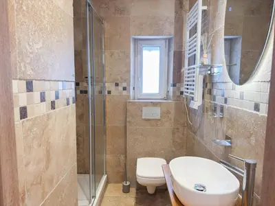 a bathroom with a sink and a toilet and a shower at Suite Palmiers bleus Cannes in Cannes
