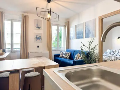 a kitchen and living room with a large sink at Suite Palmiers bleus Cannes in Cannes