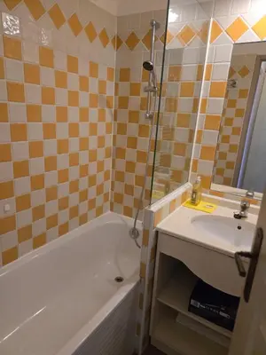 a bathroom with a tub and a sink and a bath tub at RENOIR 1265 Villa Francia - F2 très belle vue mer in Cannes