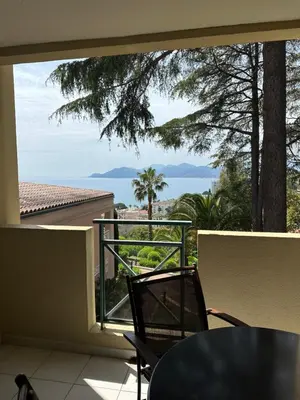 a balcony with a table and a view of the ocean at RENOIR 1265 Villa Francia - F2 très belle vue mer in Cannes