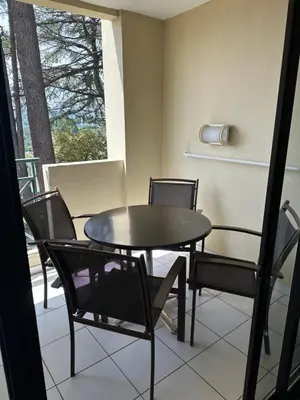 a dining room with a table and chairs on a balcony at RENOIR 1265 Villa Francia - F2 très belle vue mer in Cannes