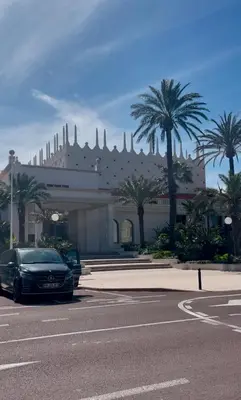 a car parked in front of a building with palm trees at Marlyn in Cannes