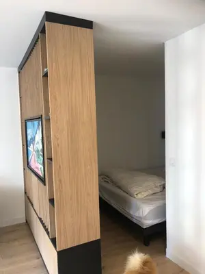 a room with a book shelf and a bed at Studio terrasse Croisette in Cannes