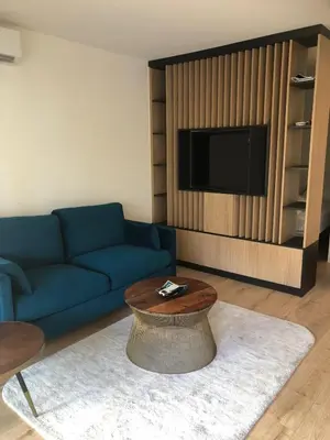 a living room with a blue couch and a table at Studio terrasse Croisette in Cannes
