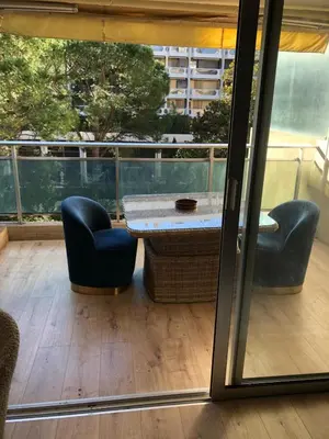 a patio with a table and two chairs and a window at Studio terrasse Croisette in Cannes