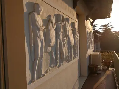 a wall with reliefs on the side of a building at CANNES Vue Mer & Balcon dans Villa Exceptionnelle Belle Époque la Californie in Cannes