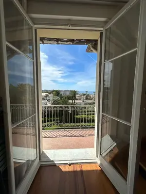 an open glass door with a view of a balcony at CANNES Vue Mer & Balcon dans Villa Exceptionnelle Belle Époque la Californie in Cannes