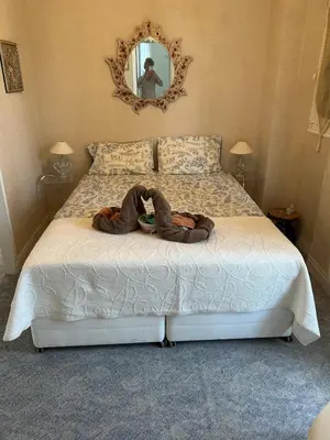 a person laying on a bed in a bedroom at CANNES Vue Mer & Balcon dans Villa Exceptionnelle Belle Époque la Californie in Cannes