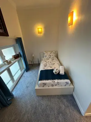a bedroom with a bed with a teddy bear on it at CANNES Vue Mer & Balcon dans Villa Exceptionnelle Belle Époque la Californie in Cannes