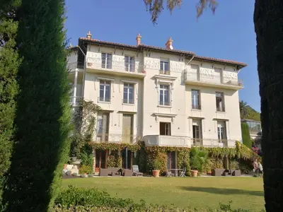 a large white building on a grass field at CANNES Vue Mer & Balcon dans Villa Exceptionnelle Belle Époque la Californie in Cannes