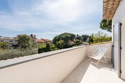 a white chair sitting on the balcony of a house at One of a kind 6 BR 6 bath villa sauna jacuzzi pool just 15 mns off town in Cannes