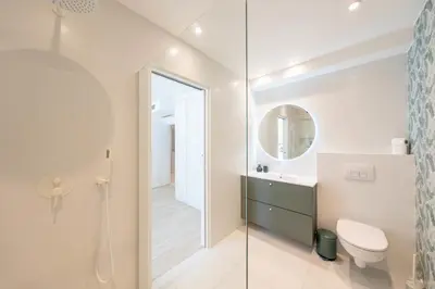 a bathroom with a toilet and a sink and a mirror at One of a kind 6 BR 6 bath villa sauna jacuzzi pool just 15 mns off town in Cannes