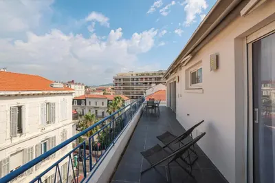 a balcony with chairs and a view of the city at REF 1493 - Cannes -City Center Banane District in Cannes