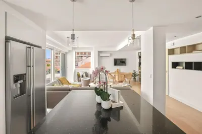 a kitchen and living room with a table with flowers on it at REF 1493 - Cannes -City Center Banane District in Cannes