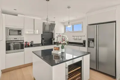a kitchen with white appliances and a counter top at REF 1493 - Cannes -City Center Banane District in Cannes