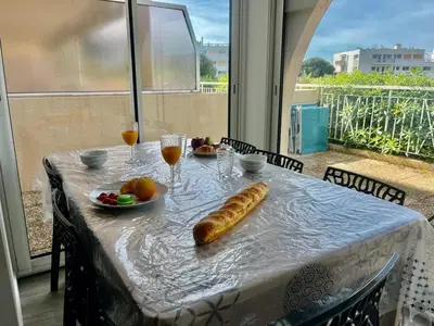 a table with a plate of bread and drinks on it at Holidays in Cannes