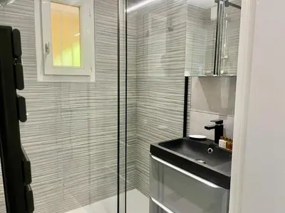 a bathroom with a sink and a glass shower at Holidays in Cannes