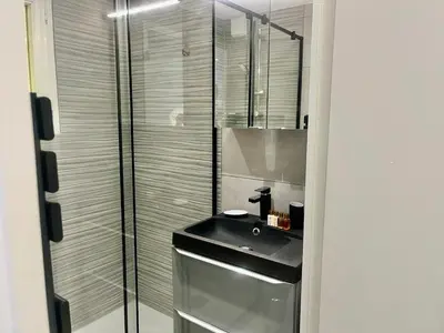 a bathroom with a sink and a glass shower at Holidays in Cannes