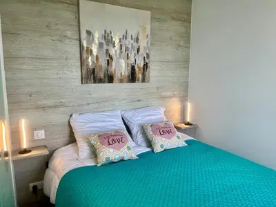 a bedroom with a bed with two pillows saying love at Holidays in Cannes