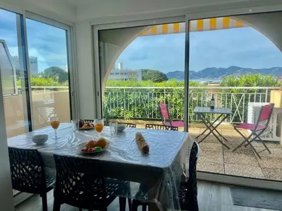 a table with a plate of food on a balcony at Holidays in Cannes