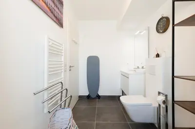 a small bathroom with a toilet and a sink at Immogroom - t2 new - bright - fully equipped in Cannes