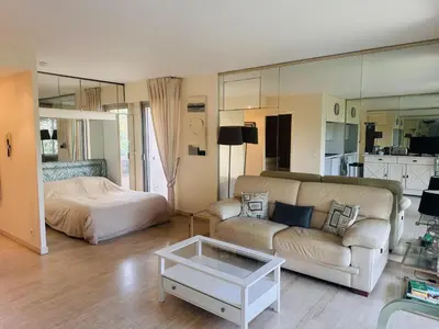 a living room with a couch and a bed at Light modern Studio with Garden terrace shared pool - 2294 in Cannes