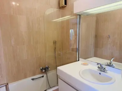 a bathroom with a sink and a shower with a mirror at Light modern Studio with Garden terrace shared pool - 2294 in Cannes