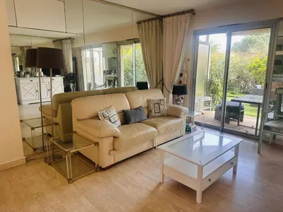 a living room with a couch and a table at Light modern Studio with Garden terrace shared pool - 2294 in Cannes