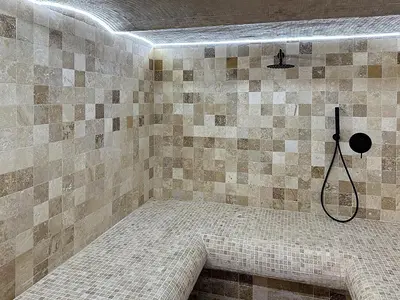 a bathroom with a shower with a tiled wall at Modern 5-bedroom villa with swimming pool in Cannes in Cannes