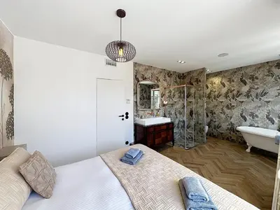 a bedroom with a bed and a tub and a sink at Modern 5-bedroom villa with swimming pool in Cannes in Cannes