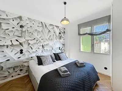 a bedroom with a large bed with a wall mural at Modern 5-bedroom villa with swimming pool in Cannes in Cannes