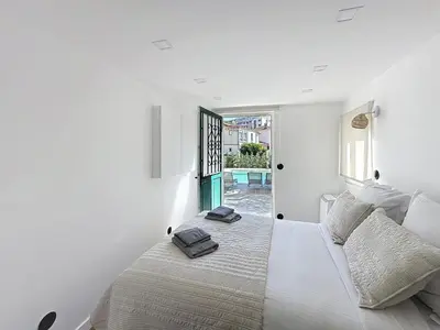 a white bedroom with a bed with two towels on it at Modern 5-bedroom villa with swimming pool in Cannes in Cannes