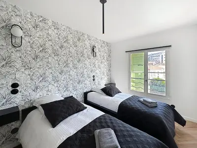 a bedroom with two beds and a window at Modern 5-bedroom villa with swimming pool in Cannes in Cannes