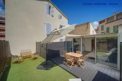 a patio with a table and chairs on a balcony at VCA House -5 appartements - 15Min Mer- Wifi-Clim in Cannes