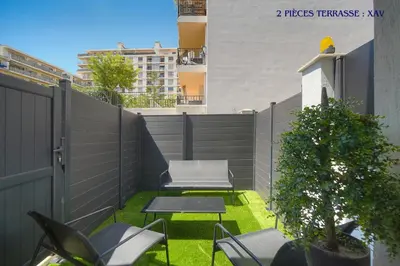 a small garden with chairs and a table on a balcony at VCA House -5 appartements - 15Min Mer- Wifi-Clim in Cannes