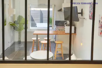 a kitchen with a table and stools in a room at VCA House -5 appartements - 15Min Mer- Wifi-Clim in Cannes